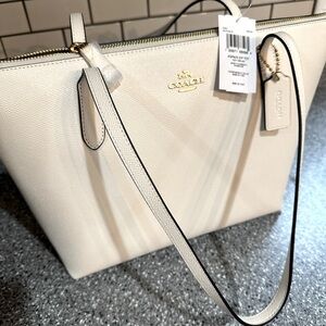 Brand new, Authentic Coach. Gorgeous chalk color, brown inside, gold hardware.